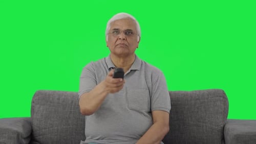 Indian old man watching TV Green screen