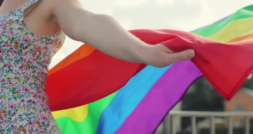 Person Holding Rainbow Flag on a Sunny Day