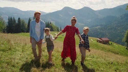 Carefree Family Stroll on Mountain Slope Summer Holiday. Cheerful Couple Walking With