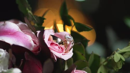 Wedding Rings Displayed in Bouquet of Pink Roses