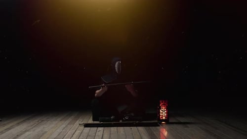 Man In Kendogu Sitting While Unsheathing Katana