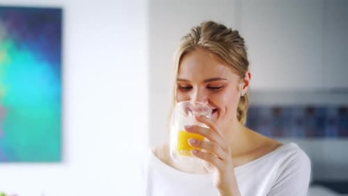 Girl Drinking Fresh Orange Juice From Glass. Close Up Happy Woman Drinking Fruit Beverage. Pretty...