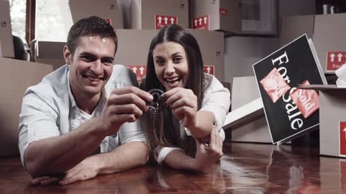 Happy Couple Holding New House Keys in New Home