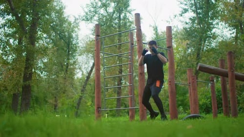 Man Boxing in Outdoor Green Space Workout