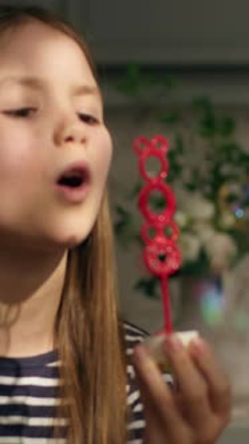 Caucasian Little Girl Child Kid Daughter Baby Blowing Soap Bubbles at Home Having Fun with Toy