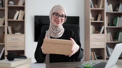 First Person View of Muslim Female Blogger Opening Gift Box