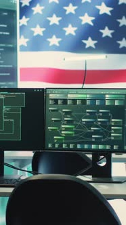Computers Displaying Data with American Flag Backdrop