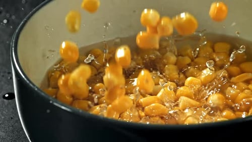 Corn Kernels Dropping into Water