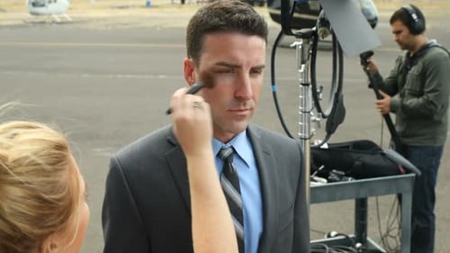 Hollywood actor getting makeup applied backstage on a film set