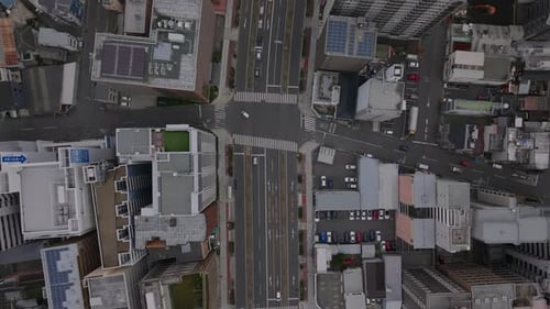 Fly Above Wide Street in Urban Borough Birds Eye Shot of Town Development Buildings and Streets in