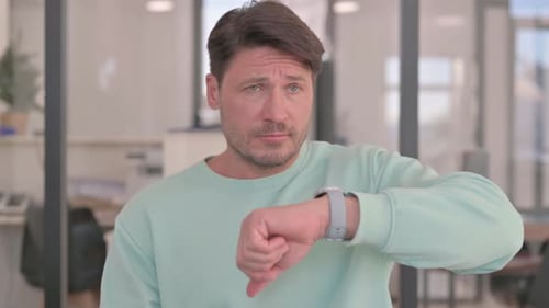 Portrait of Waiting Man Checking Time on Wrist Watch