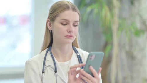 Young Doctor Using a Smartphone in a Hospital