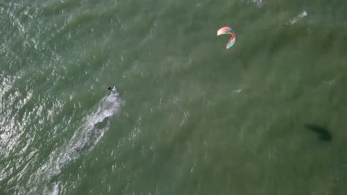 Aerial following footage of a Kite surfer at The Mediterranean Sea.