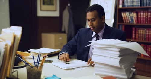 Focused Professional Black Man Stamping Stack Of Paper Frantically In Interior Lawyer Office With...