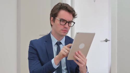 Business Man Using Tablet in Bright Indoor Setting