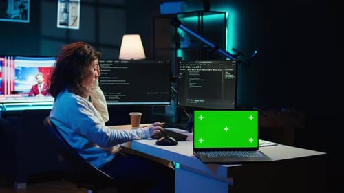 Admin Using Green Screen Laptop to Implement Security Measures