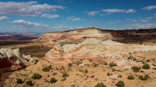 Downward slight spiral sweeping drone shot of the stunning white pocket cliffs vermilion.