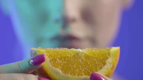 Female eating orange fruit