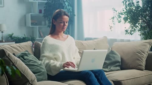 Woman Working on Laptop Computer at Home