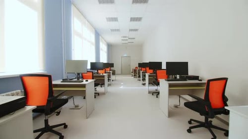 Workplaces with Modern Computers in Empty Long Office Room