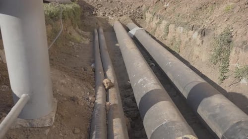 Water Pipes in a Trench Outdoors During the Day