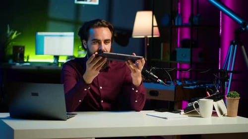 Man Holding Tablet Giving Technology Review