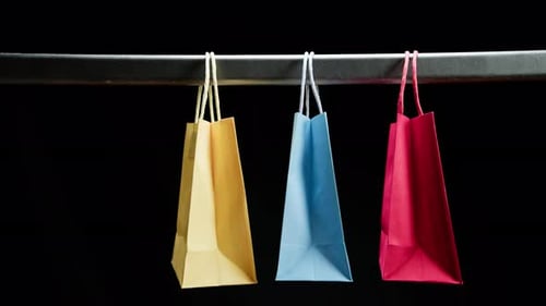 Colorful Shopping Bags Hanging From Bar