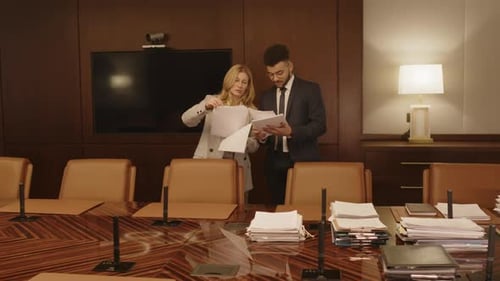 Dos abogados discuten un documento en la sala de conferencias