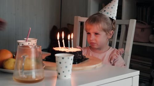 Cute Girl Blows Out Birthday Cake Candles