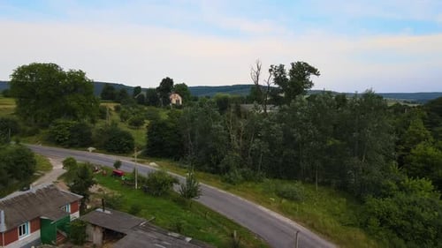Aerial Landscape View of Village Houses and Distant Green Cultivated Agricultural Fields with