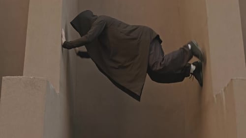Parkour Athlete Ascends Between Two Walls