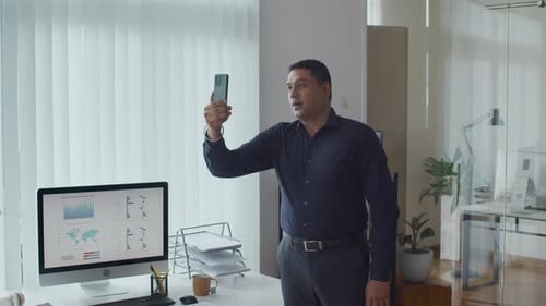 Specialist Calling on Video via Smartphone at Office