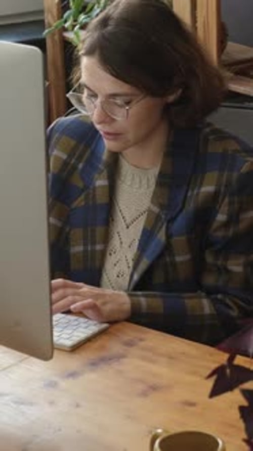 Vertical Video Woman Typing on Keyboard While Sitting Desk in Home Office