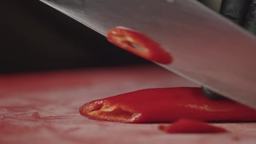 Slicing a Chili Pepper with a Knife Closeup Slow Motion Video