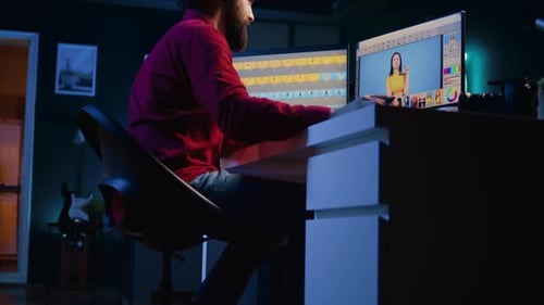 Man Edits Photograph in Dark Urban Workplace