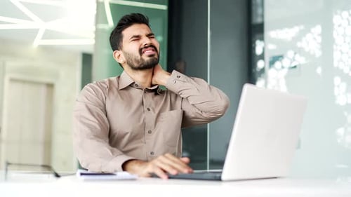 Man in Office with Neck Pain