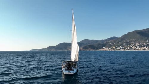 Sailboat Cruising Calm Blue Ocean on Sunny Day