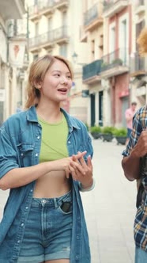 Young Adults Walking and Talking on Urban Street