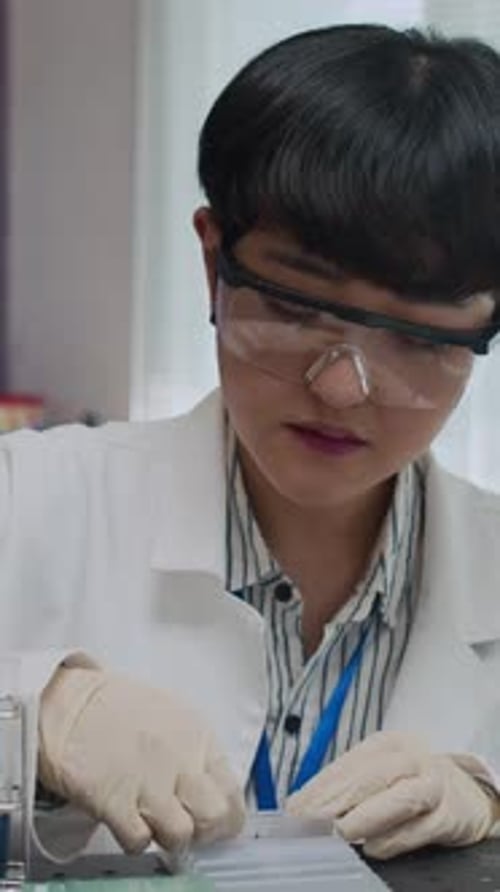 Scientist Working in Lab with Slide