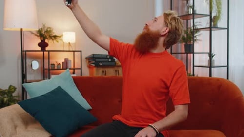 Man Vlogging with Smartphone on Tripod Indoors