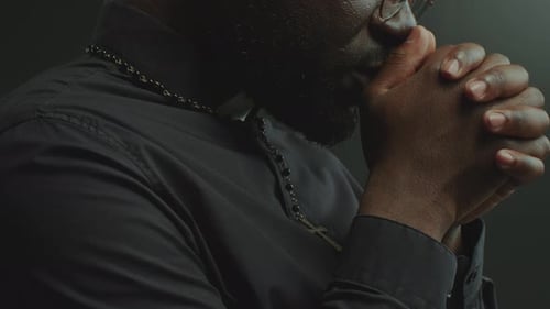Close-Up of Catholic Priest Whispering Prayer