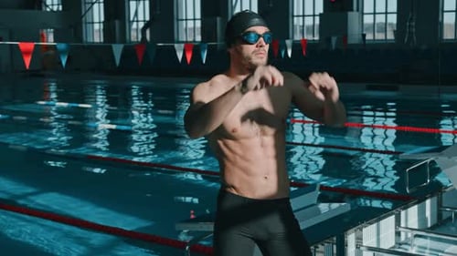 Muscular Sportsman Warming Up before Practice in Swimming Pool