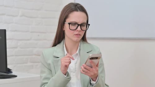 Woman Reacts With Disappointment While Using Phone