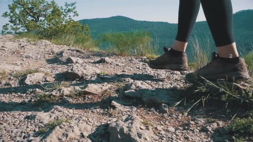View on Feet of Traveler Woman Hiking Walking on the Top of Cliff in Mountain Walking on Rocks