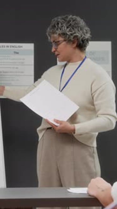 Teacher Explaining Lesson to Student in Classroom