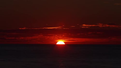 Timelapse with Sunset and Cumulus Clouds Flying High in a Beautiful Blue Sky Sun Dawn Over the Sea