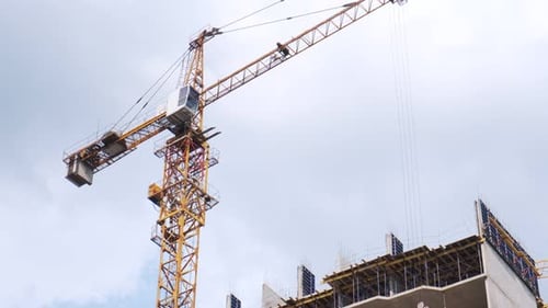 Crane. Self-erecting crane over a construction site. Crane near the building. Unfinished building on