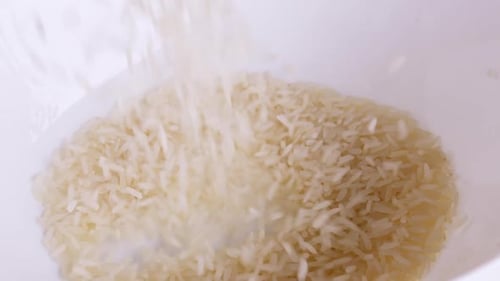 Rice grains that have been cleaned of husks into bowls ready to be cooked and consumed, rice is the