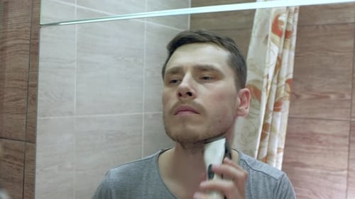 Man Shaving With Electric Razor