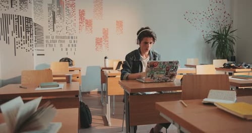 A Guy in Headphones Uses Laptop Classroom School Loses Headphones Surprised Around Anybody Homework